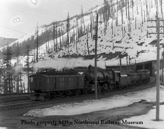 Electric locomotive prepares to pull a freight through the Cascade Tunnel