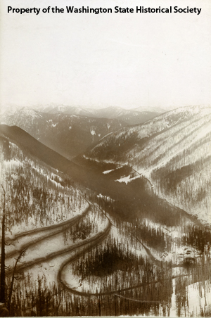 Stevens Pass switchbacks with the town of Wellington at the lower right.  View is facing west.